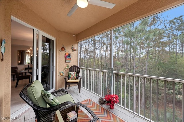 sunroom / solarium featuring ceiling fan