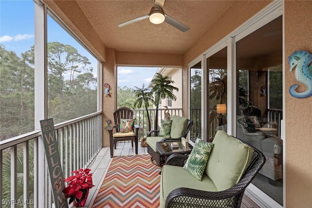 sunroom / solarium featuring ceiling fan