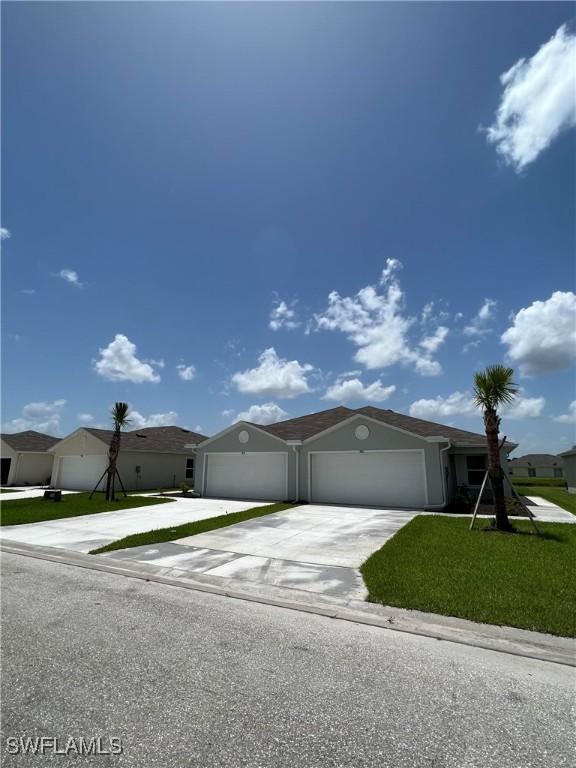 view of front of property featuring a garage and a front lawn