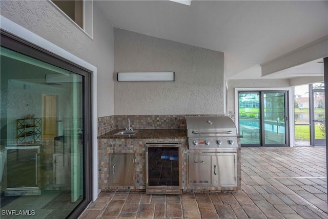 kitchen featuring refrigerator and sink