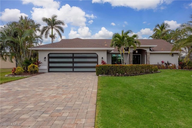 single story home featuring a front yard and a garage