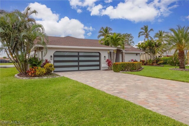 single story home featuring a front yard and a garage