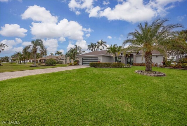 ranch-style house with a front yard and a garage