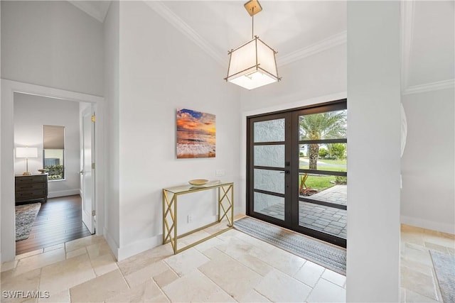 entrance foyer featuring crown molding and french doors