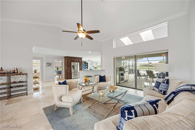 living room with high vaulted ceiling, ceiling fan, and ornamental molding