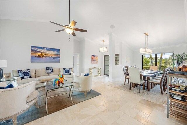 living room featuring ceiling fan, vaulted ceiling, and ornamental molding