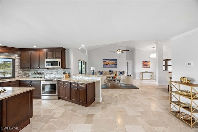 kitchen featuring backsplash, plenty of natural light, stainless steel appliances, and vaulted ceiling