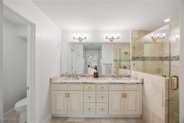 bathroom with vanity, toilet, walk in shower, and ceiling fan