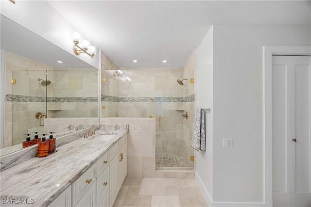 bathroom with tile patterned floors, a shower with door, and vanity