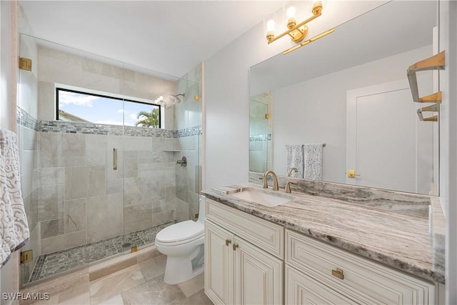 bathroom featuring vanity, an enclosed shower, and toilet