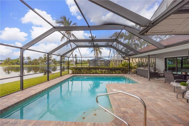 view of swimming pool featuring a patio, a water view, and a lanai