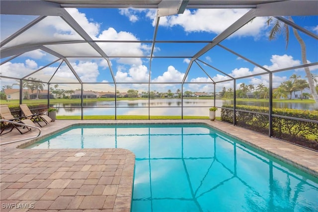 view of swimming pool featuring a lanai, a patio area, and a water view