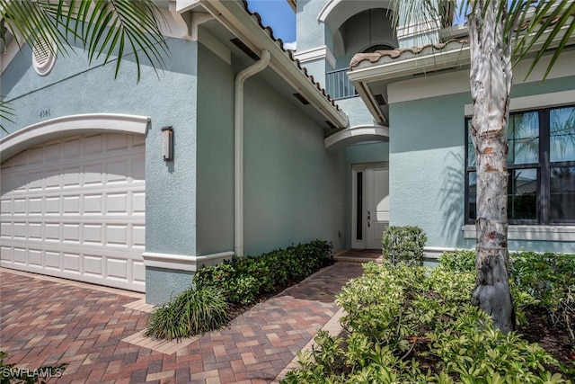 view of exterior entry with a garage