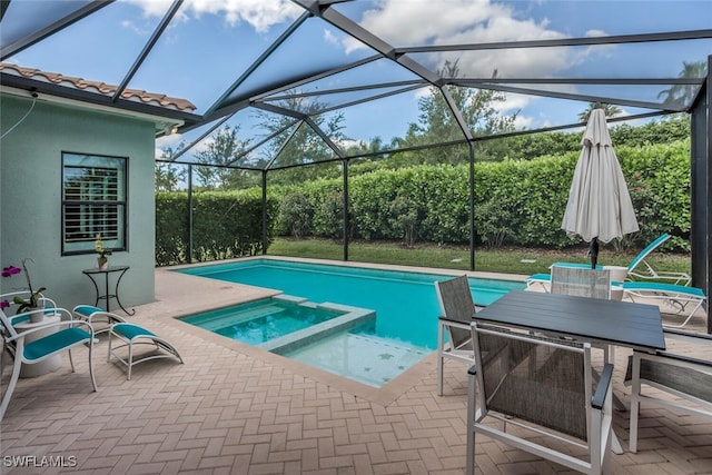 view of swimming pool with a lanai, a patio area, and an in ground hot tub