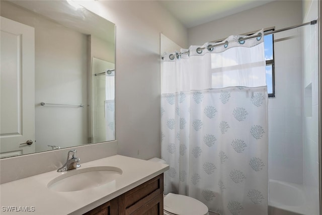 full bathroom featuring shower / bath combo with shower curtain, vanity, and toilet