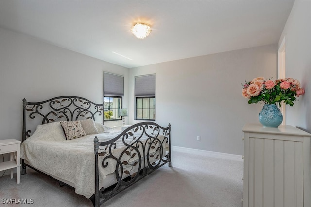 bedroom featuring light carpet