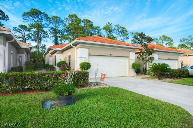 view of front of home with a front yard and a garage