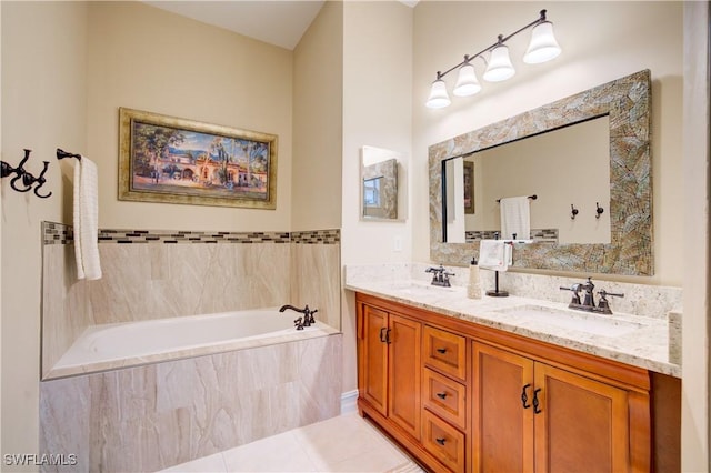 bathroom featuring tile patterned floors, a relaxing tiled tub, and vanity