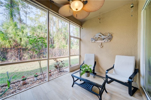 sunroom / solarium featuring ceiling fan