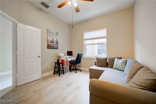 home office featuring light hardwood / wood-style flooring and ceiling fan