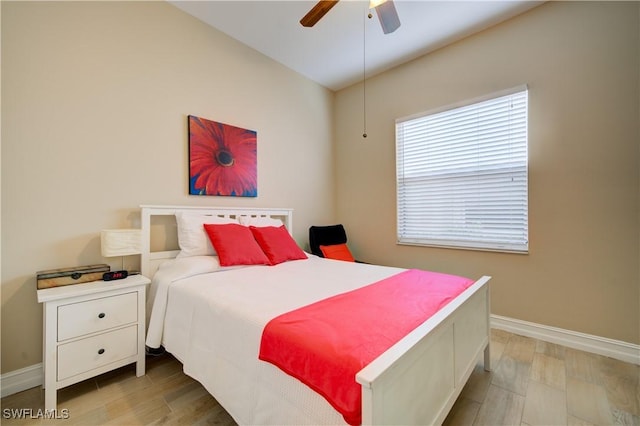 bedroom featuring multiple windows, ceiling fan, and light hardwood / wood-style floors