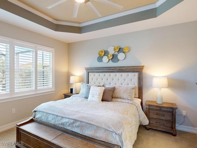 bedroom with light carpet, a raised ceiling, ceiling fan, and ornamental molding