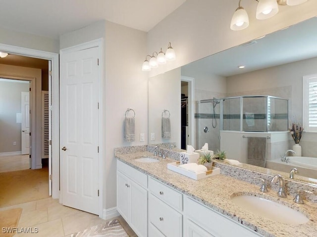 bathroom featuring tile patterned flooring, vanity, and plus walk in shower