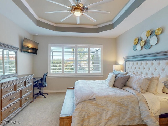 carpeted bedroom featuring ceiling fan, a raised ceiling, and crown molding