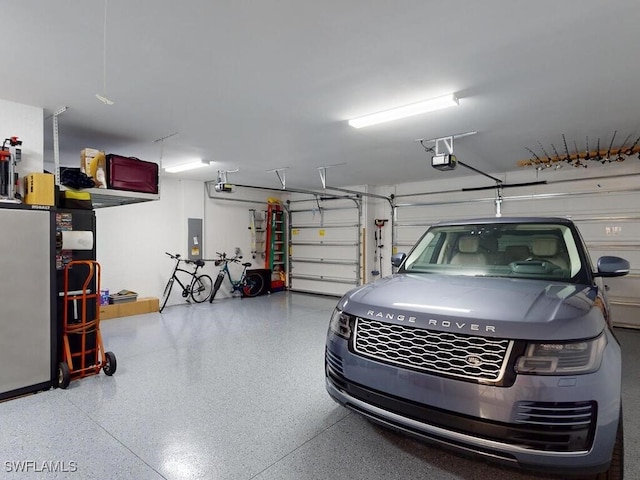 garage with electric panel and a garage door opener