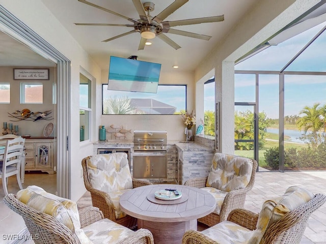 sunroom / solarium featuring a wealth of natural light and ceiling fan