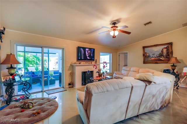 tiled living room featuring vaulted ceiling and ceiling fan