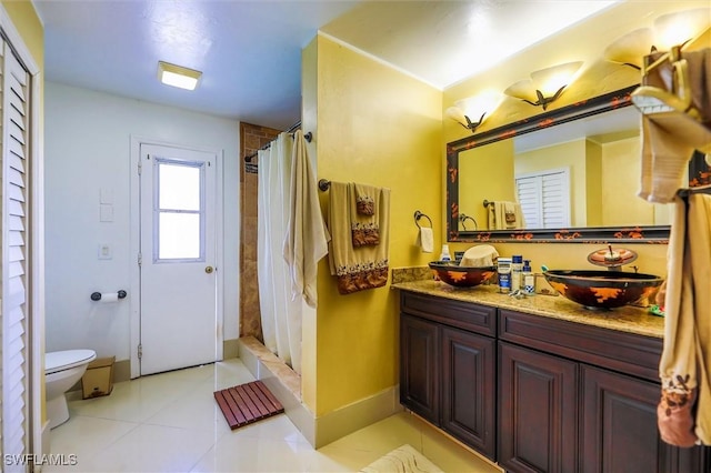 bathroom featuring tile patterned flooring, vanity, toilet, and a shower with curtain