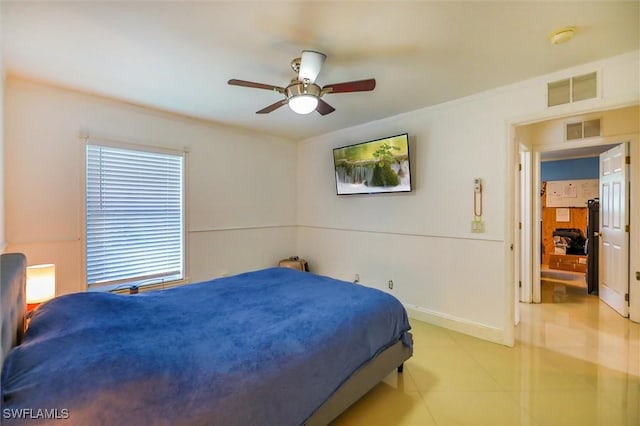 tiled bedroom featuring ceiling fan