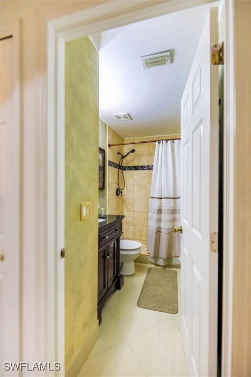 bathroom featuring a shower with curtain, tile patterned flooring, vanity, and toilet