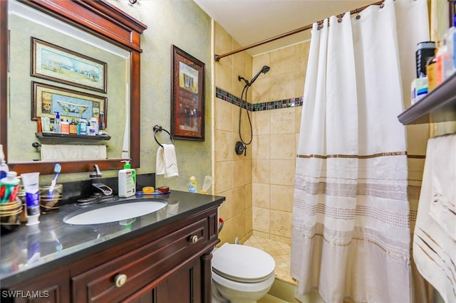 bathroom with vanity, toilet, and walk in shower