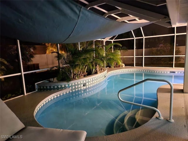 view of pool with glass enclosure