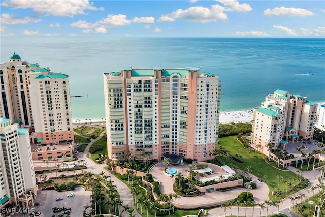 drone / aerial view featuring a water view and a view of the beach