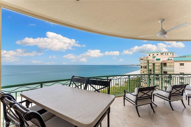 balcony with a water view and ceiling fan