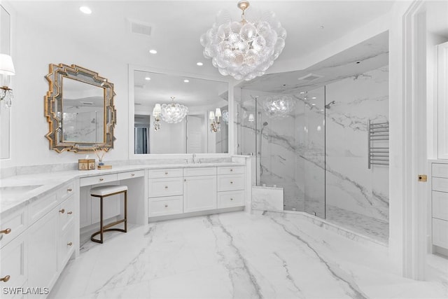 bathroom featuring an inviting chandelier, vanity, and a shower with door