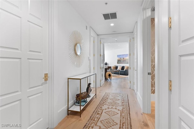 hallway with light hardwood / wood-style flooring