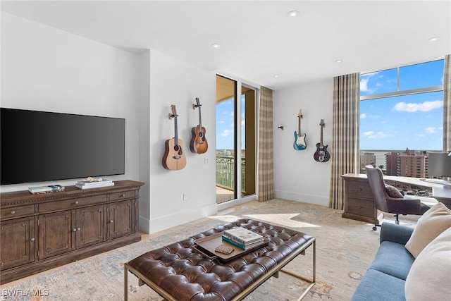 living room featuring floor to ceiling windows and a healthy amount of sunlight