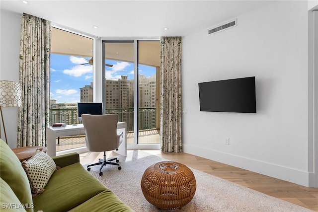 office space featuring hardwood / wood-style flooring and floor to ceiling windows