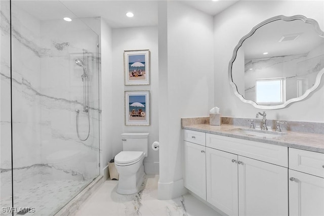 bathroom featuring tiled shower, vanity, and toilet