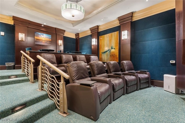 home theater with a raised ceiling and carpet flooring