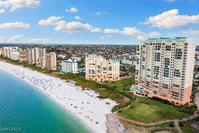 drone / aerial view featuring a beach view and a water view