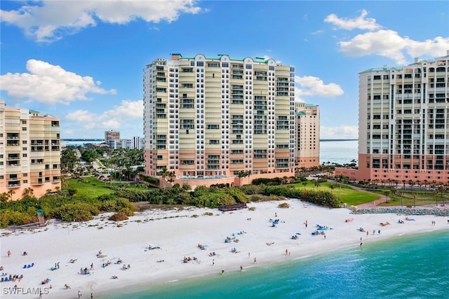 view of building exterior with a view of the beach and a water view