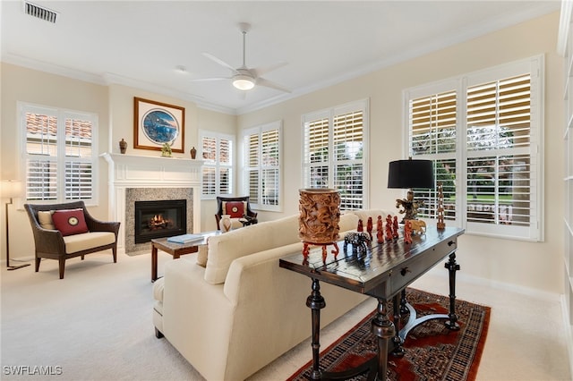 living room with ceiling fan, light colored carpet, and crown molding