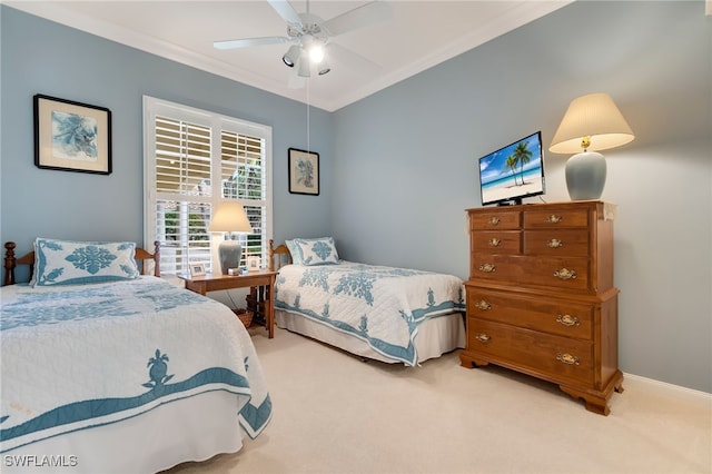 carpeted bedroom with ceiling fan and crown molding