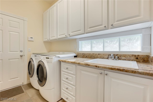 washroom featuring cabinets, separate washer and dryer, light tile patterned flooring, and sink