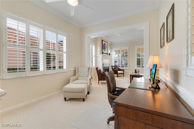 carpeted home office with a healthy amount of sunlight, ceiling fan, and ornamental molding